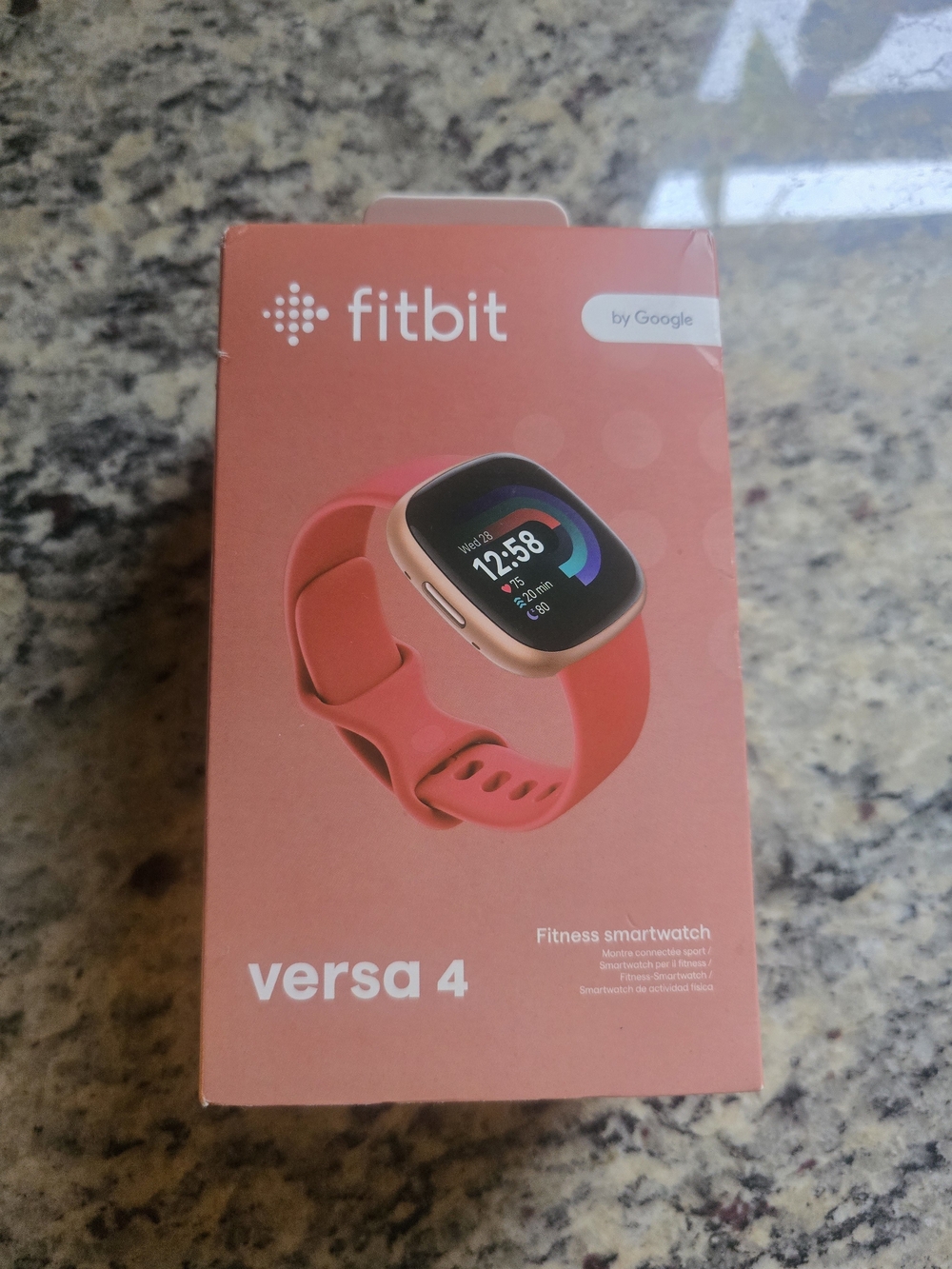 fitbit Versa 4 Smartwatch - Coral Band with Gold Case